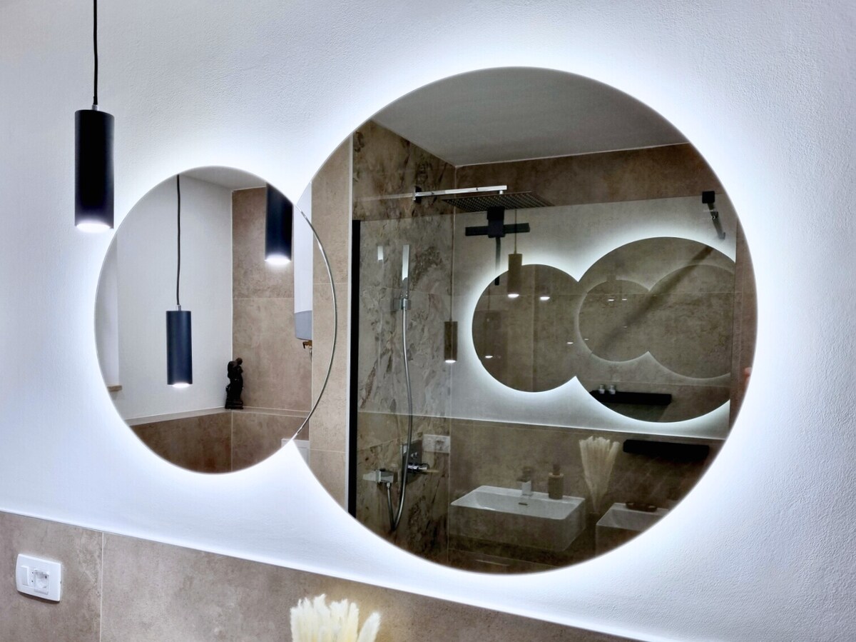 Doppelwaschbecken mit beleuchteten Rundspiegeln im Badezimmer
